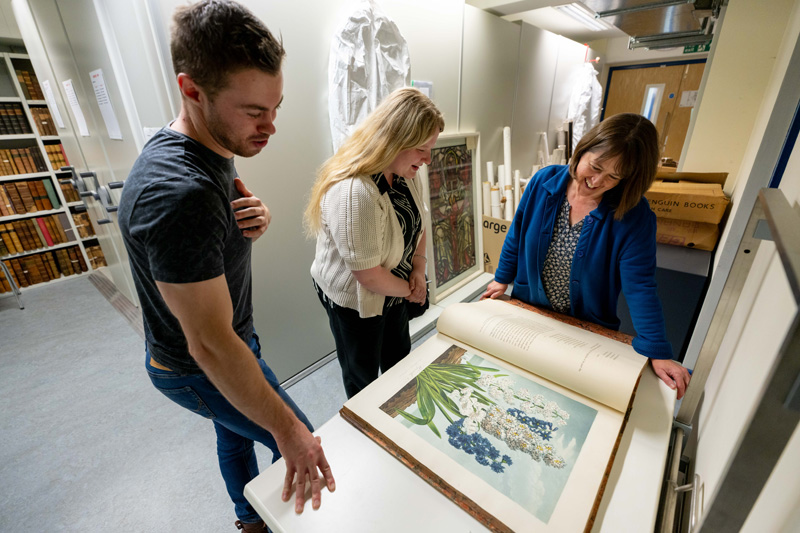 Students looking at old manuscripts