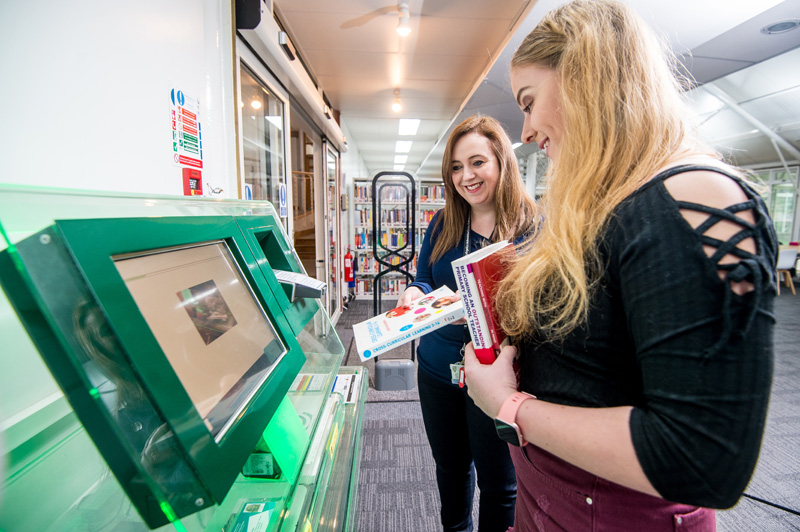 Students navigating a touch screen